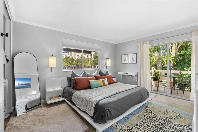 a bedroom with a bed and a large window