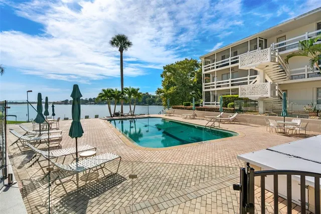 a view of a swimming pool with a table and chairs