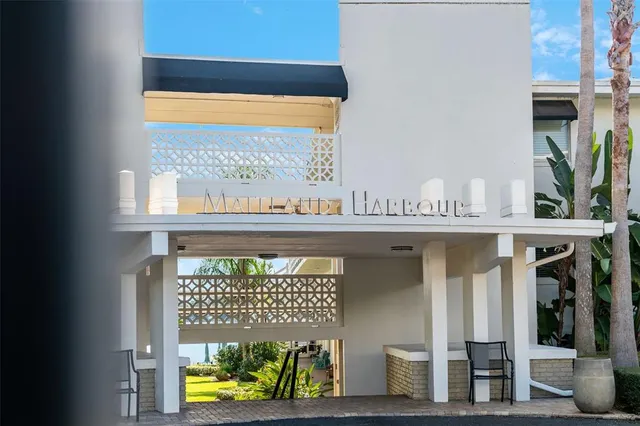a view of a chair and tables in the patio