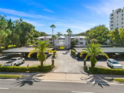 a view of a swimming pool with a deck and a yard