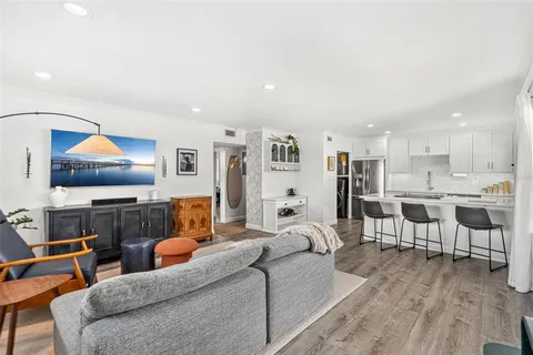 a living room with furniture and kitchen view