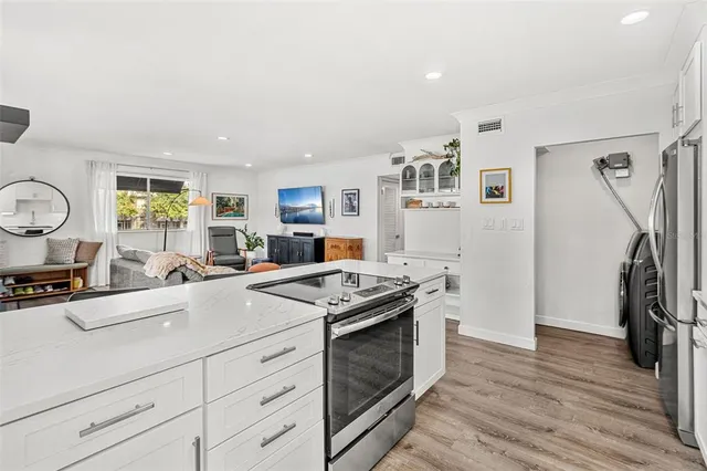 a kitchen with a stove and a refrigerator