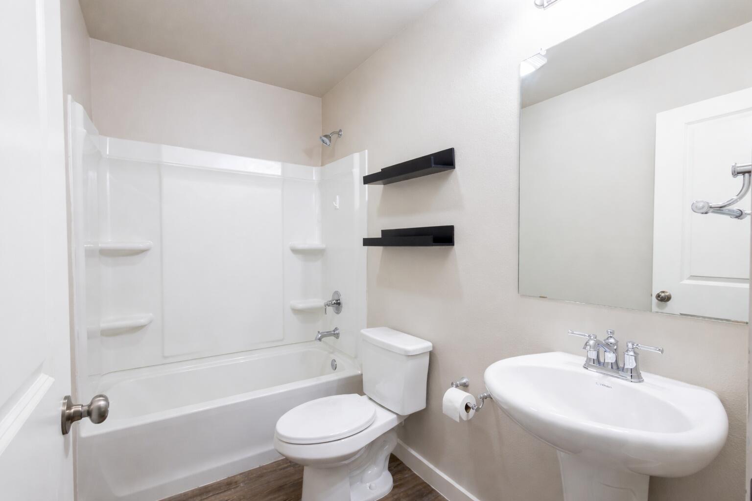 2004 134th Street Lubbock, TX 79423 - Photo 14 of 17 a bathroom with a sink toilet and shower