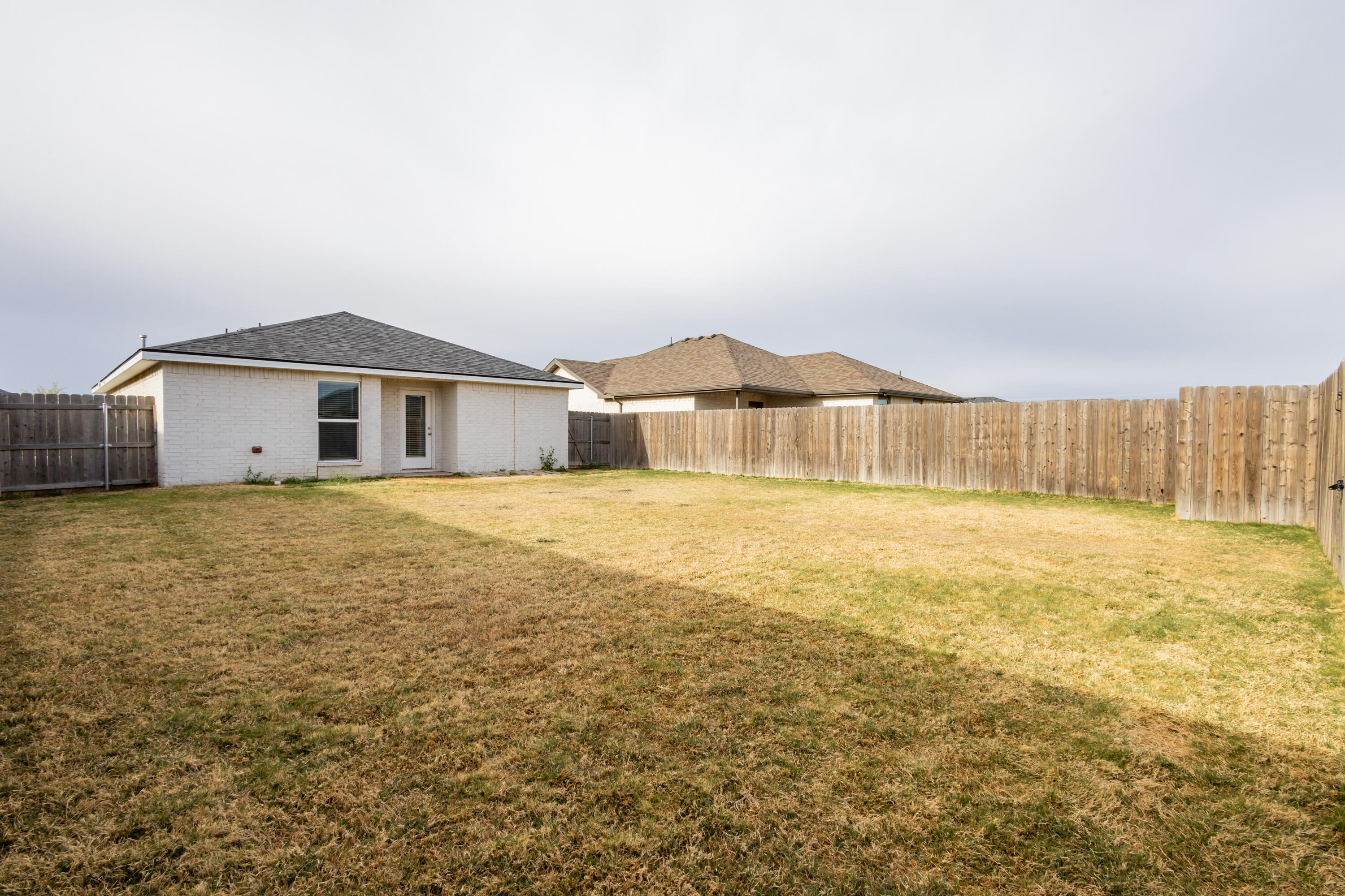 2004 134th Street Lubbock, TX 79423 - Photo 16 of 17 a view of a house with a yard
