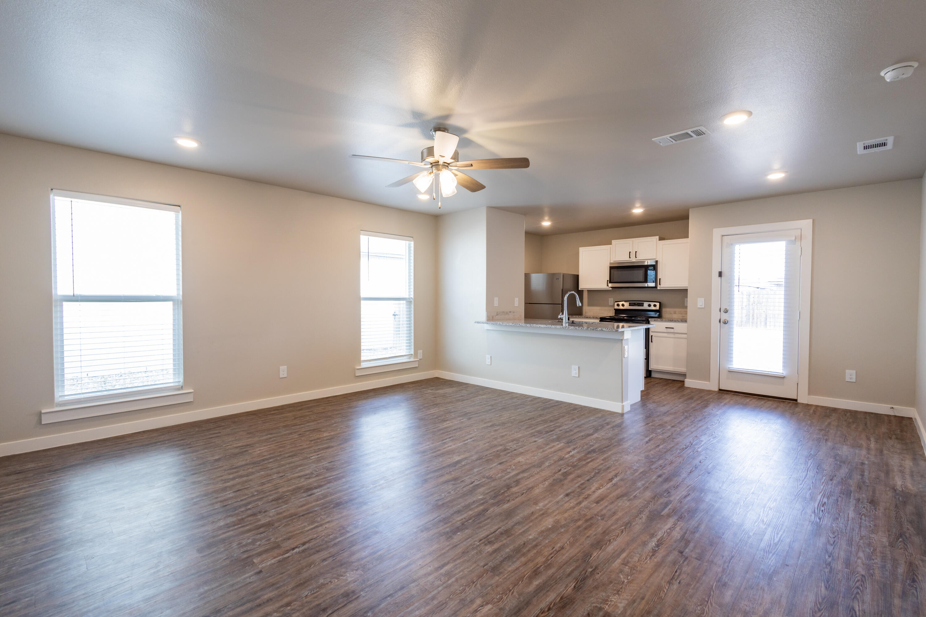2004 134th Street Lubbock, TX 79423 - Photo 4 of 17 a view of an empty room with window and wooden floor