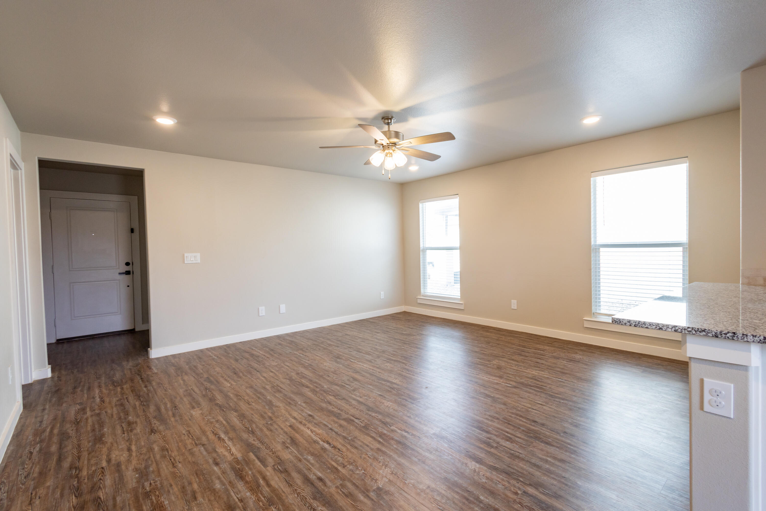 2004 134th Street Lubbock, TX 79423 - Photo 5 of 17 an empty room with wooden floor and windows