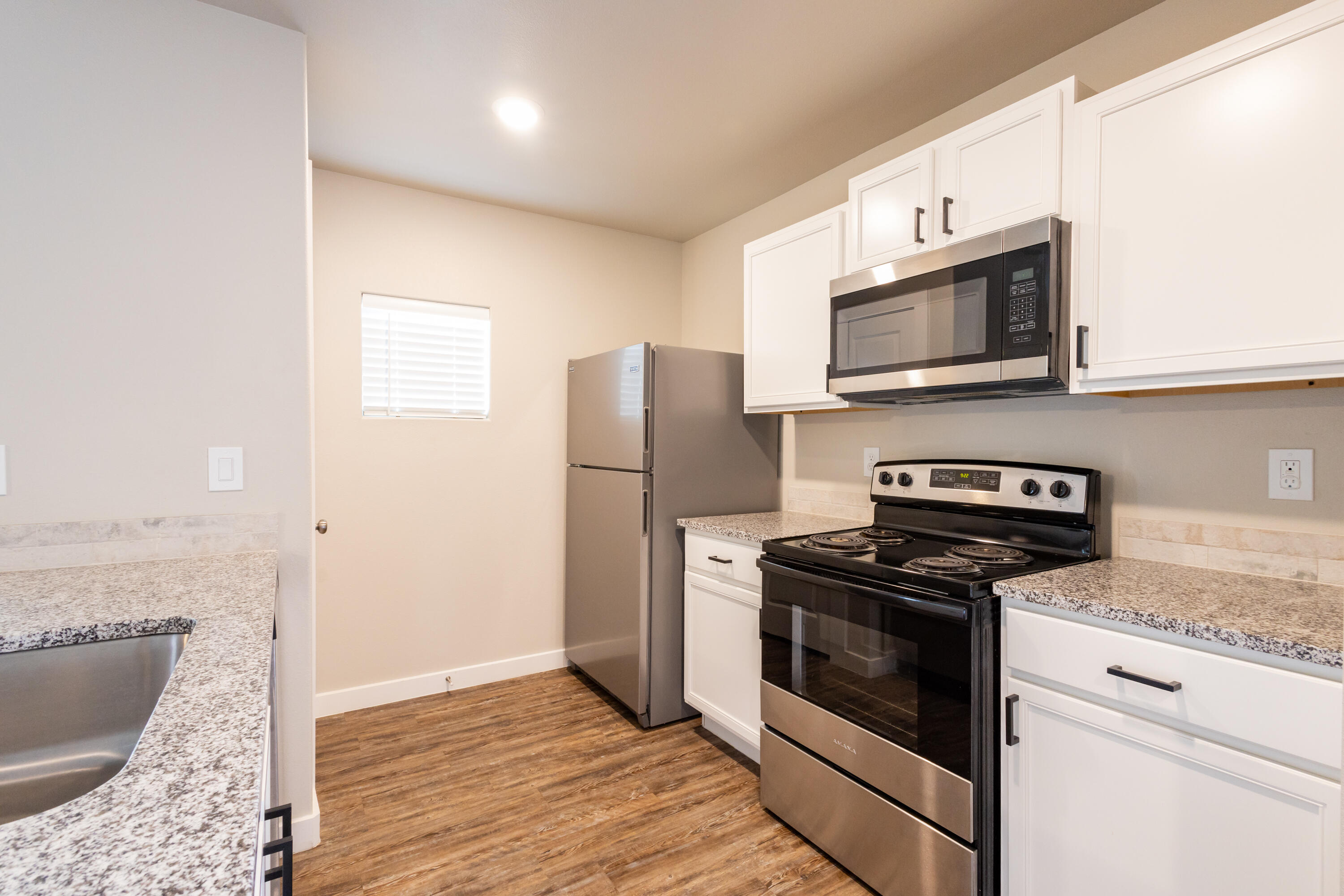2004 134th Street Lubbock, TX 79423 - Photo 7 of 17 a kitchen with stainless steel appliances granite countertop a stove a microwave and a refrigerator