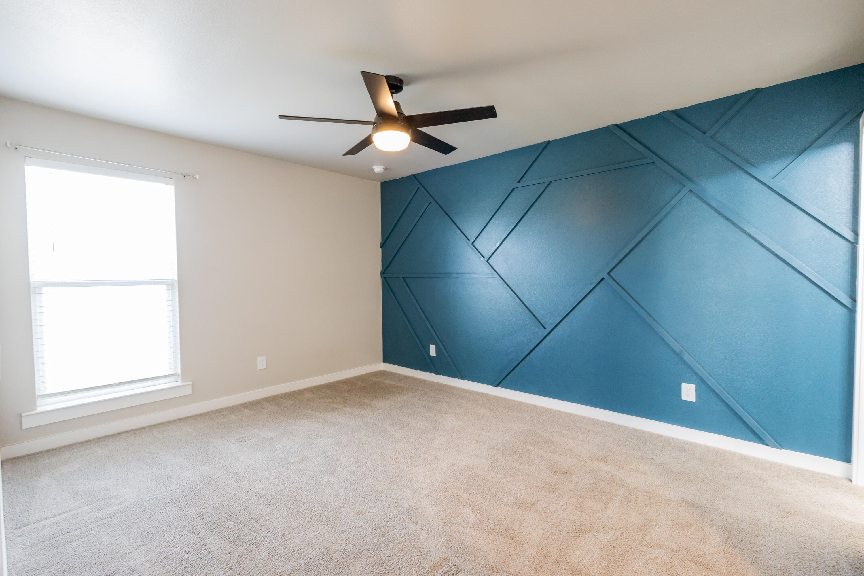 2004 134th Street Lubbock, TX 79423 - Photo 8 of 17 an empty room with a window and a fan