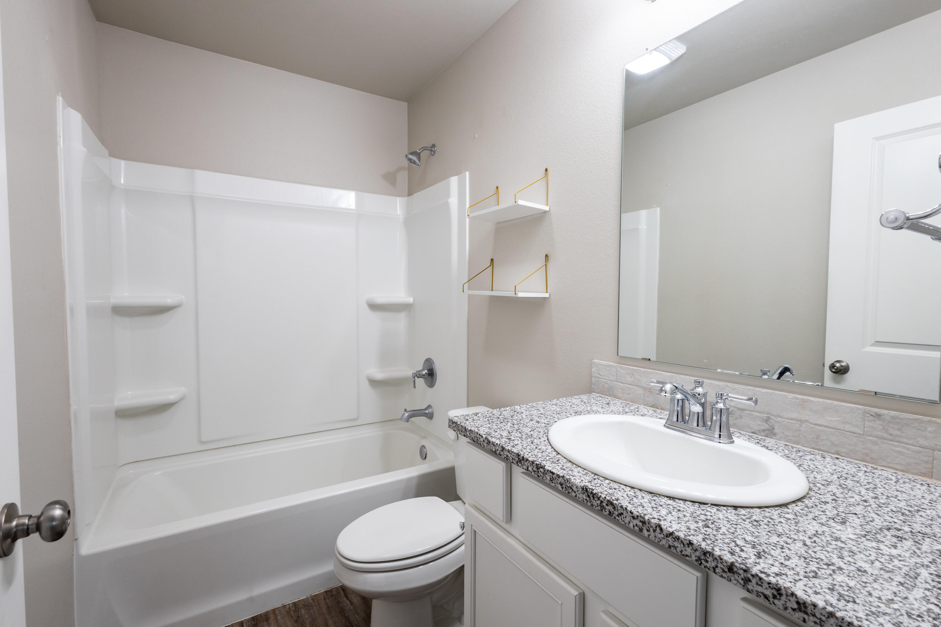 2004 134th Street Lubbock, TX 79423 - Photo 10 of 17 a bathroom with a granite countertop sink toilet and shower