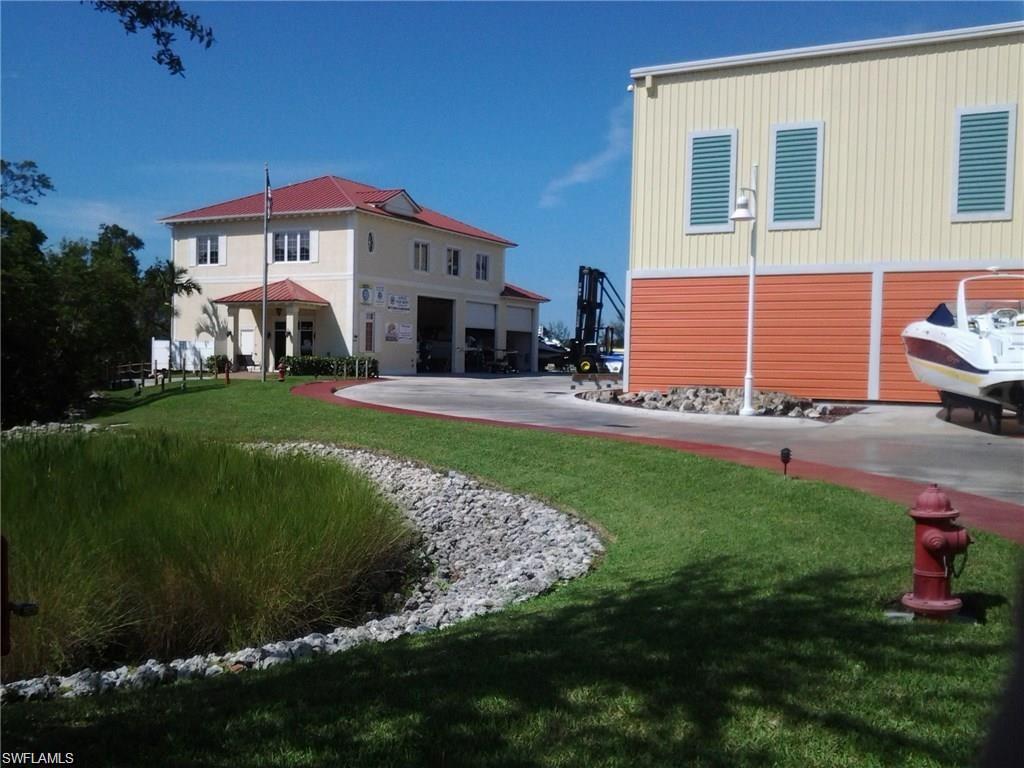 477 North Road Naples, FL 34104 - Photo 2 of 4 a front view of a house with a garden