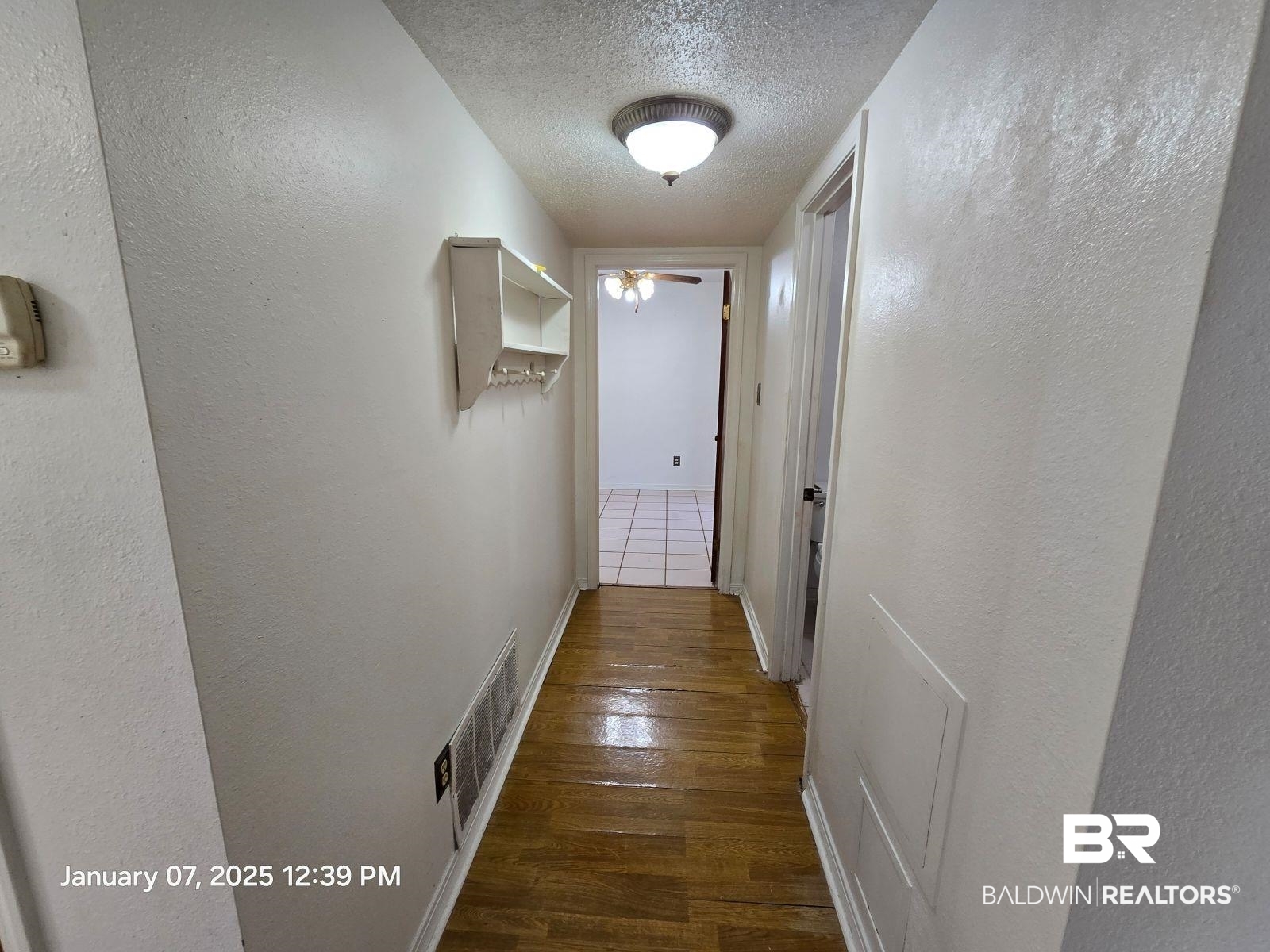 154 Byrd Road Monroeville, AL 36460 - Photo 19 of 26 Corridor with dark wood-type flooring and a textured ceiling