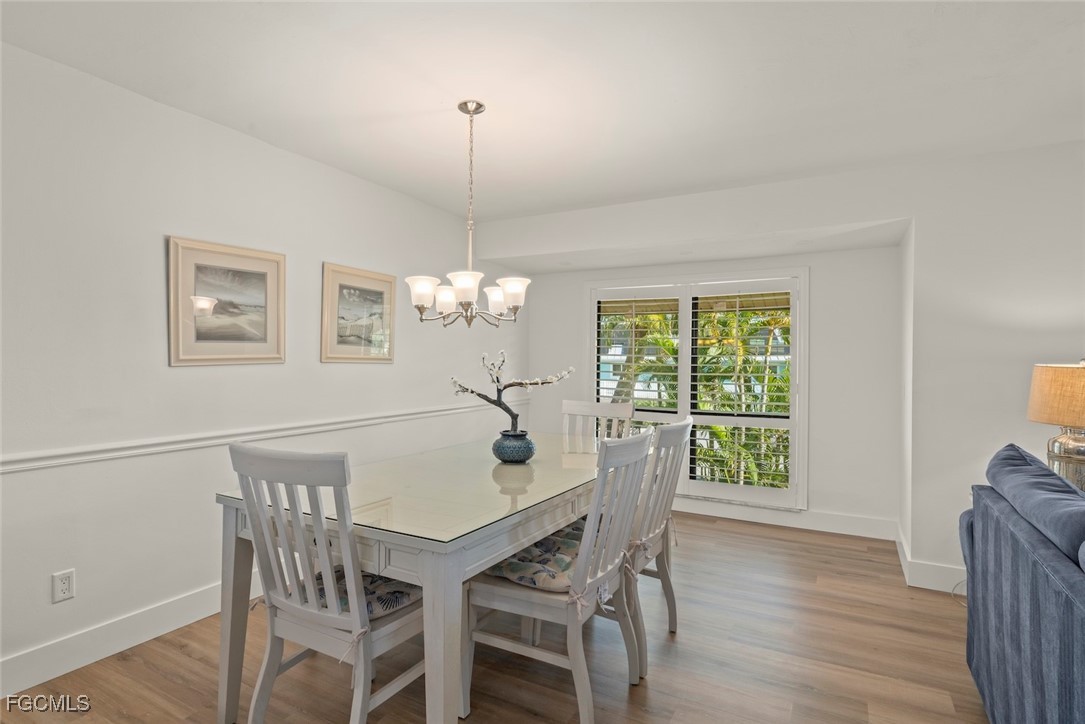5117 Sea Bell Road, Unit D204 Sanibel, FL 33957 - Photo 11 of 48 a view of a dining room with furniture window and wooden floor