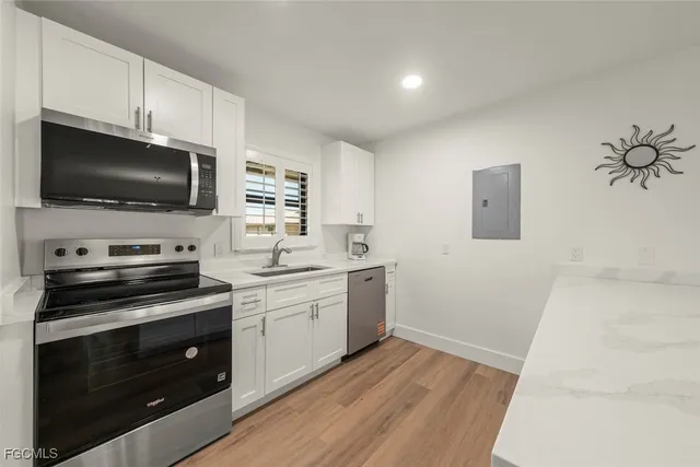 a kitchen with a sink stove and microwave