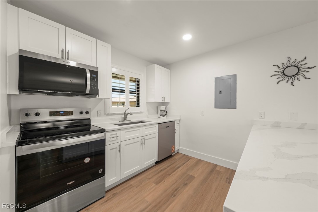 5117 Sea Bell Road, Unit D204 Sanibel, FL 33957 - Photo 17 of 50 a kitchen with a sink stove and microwave