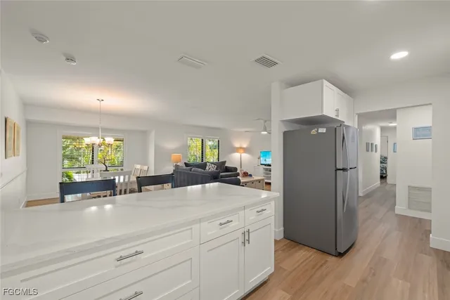 a kitchen with sink refrigerator and window