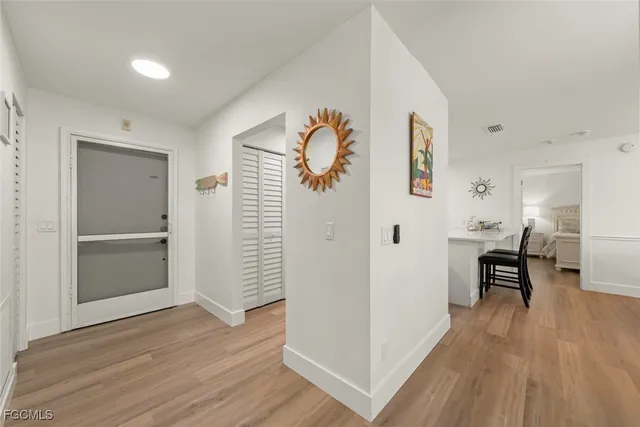 a view of dining room with wooden floor and furniture