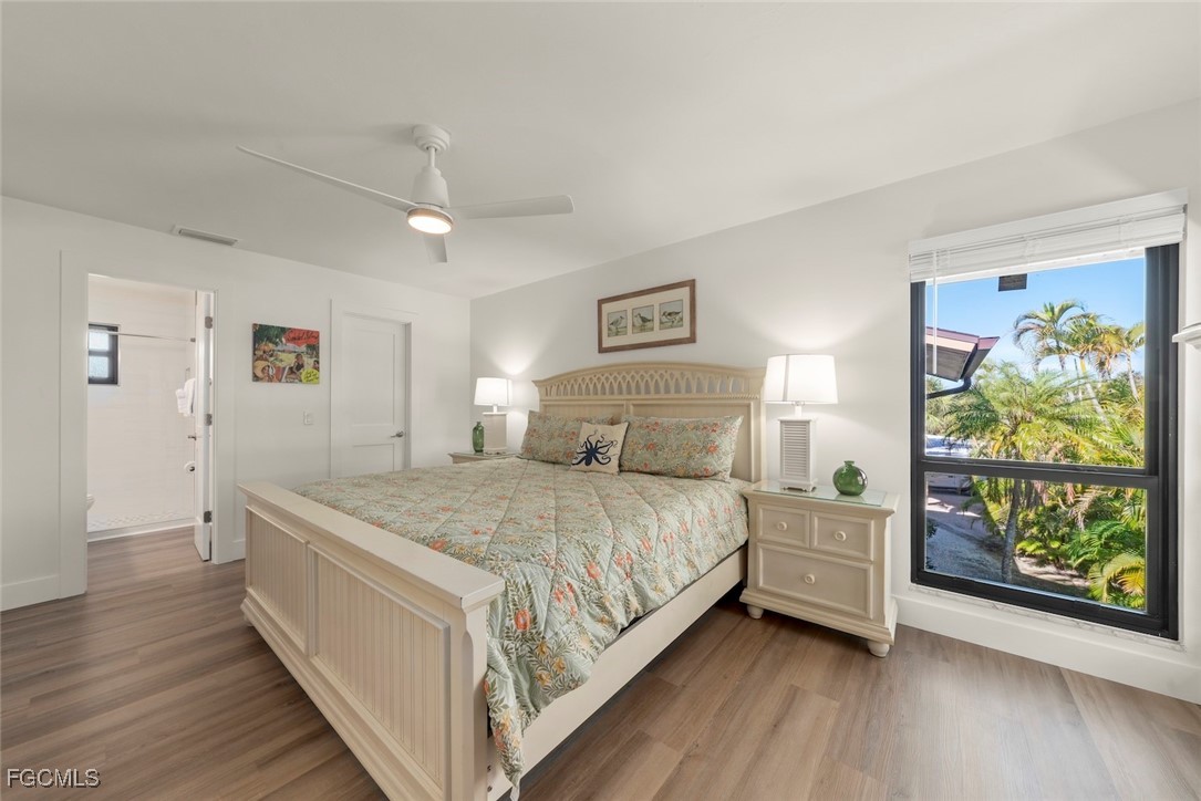 5117 Sea Bell Road, Unit D204 Sanibel, FL 33957 - Photo 26 of 48 a bedroom with a bed and painting on the wall