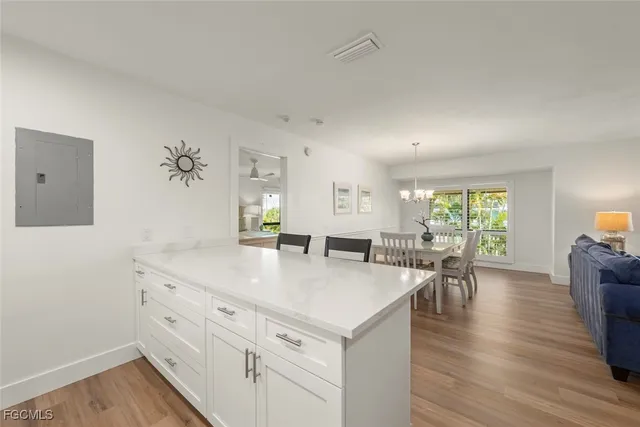 a view of a kitchen area with furniture and wooden floor