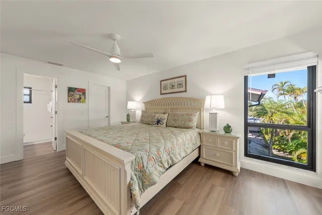 a bedroom with a bed and painting on the wall