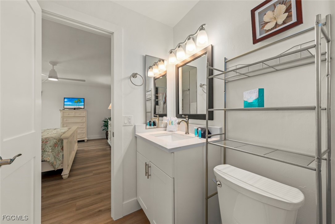 5117 Sea Bell Road, Unit D204 Sanibel, FL 33957 - Photo 30 of 48 a bathroom with a toilet sink and mirror