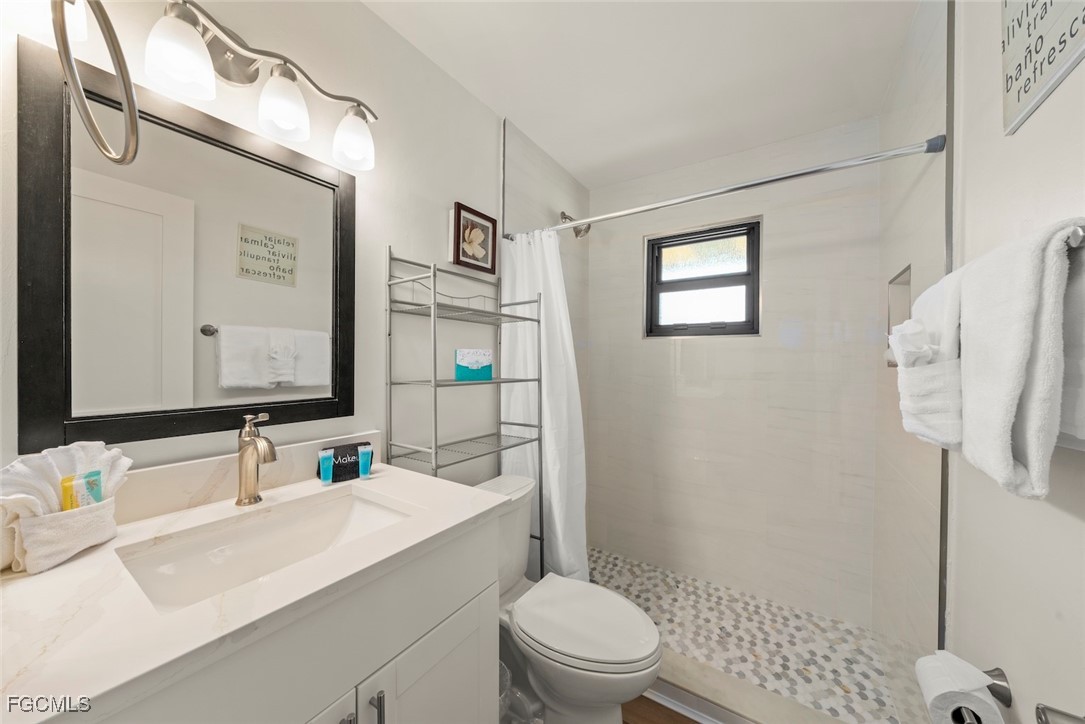 5117 Sea Bell Road, Unit D204 Sanibel, FL 33957 - Photo 31 of 50 a bathroom with a sink toilet vanity and shower