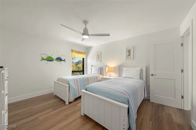 a bedroom with two beds and a chandelier