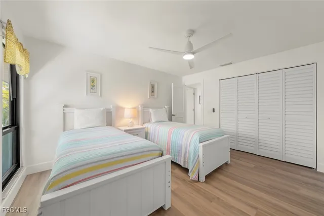 a spacious bedroom with two beds and painted walls