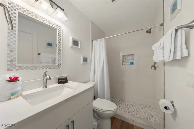 a bathroom with a sink toilet and shower