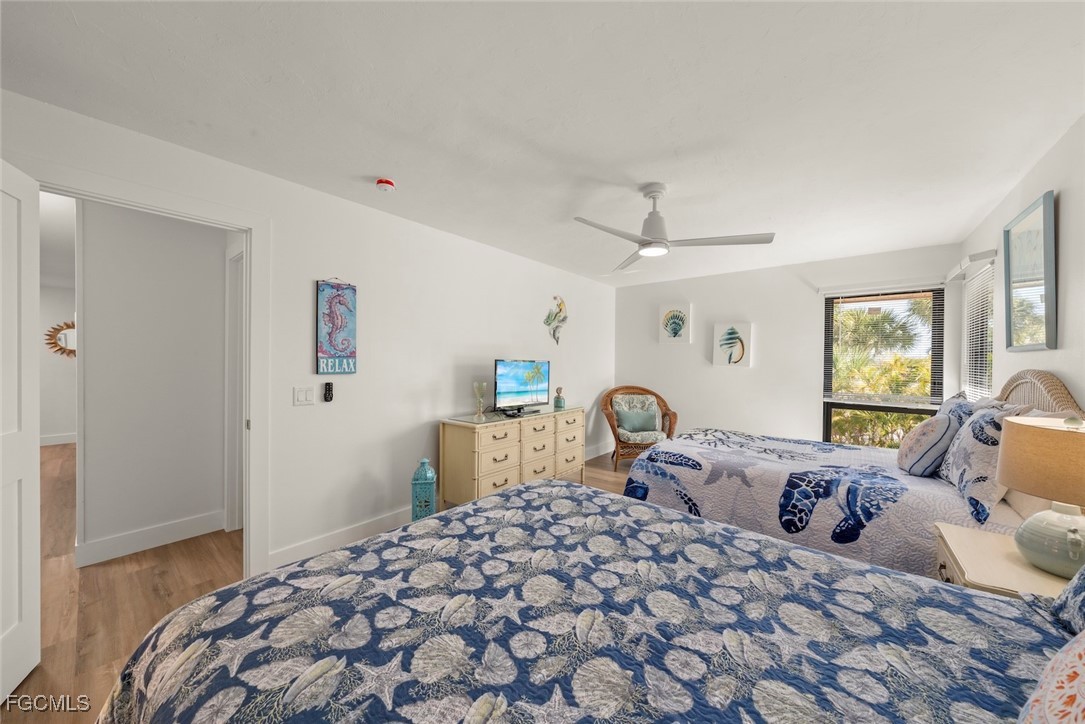 5117 Sea Bell Road, Unit D204 Sanibel, FL 33957 - Photo 40 of 48 a bedroom with a large bed and a window