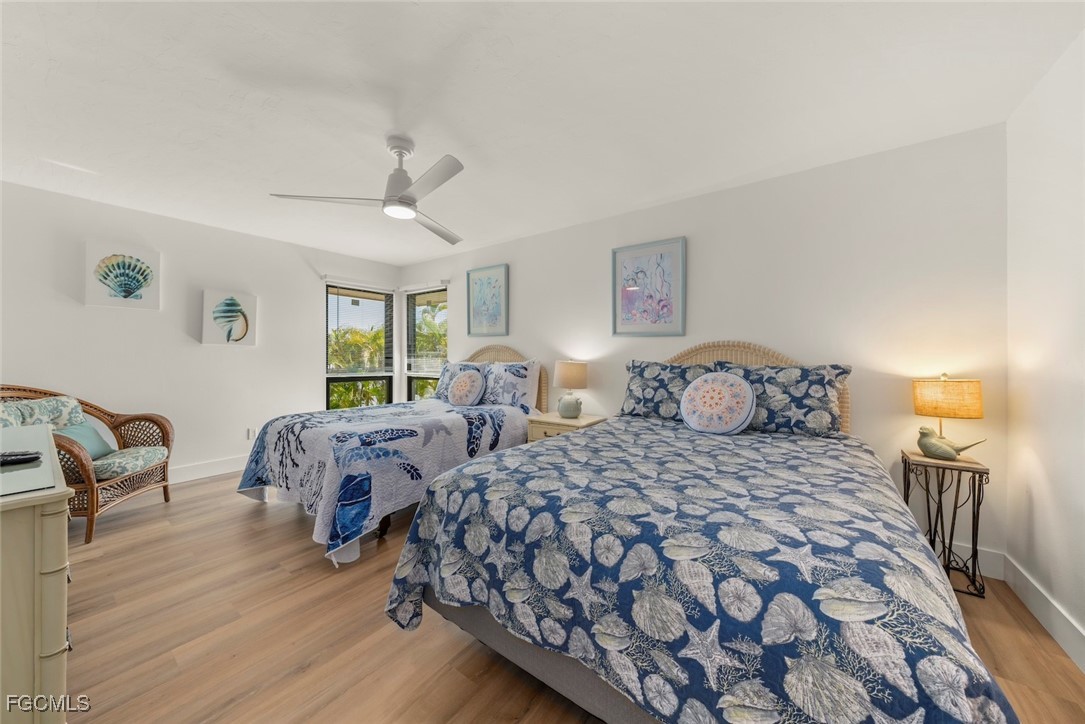 5117 Sea Bell Road, Unit D204 Sanibel, FL 33957 - Photo 40 of 50 a bedroom with two beds and a chandelier