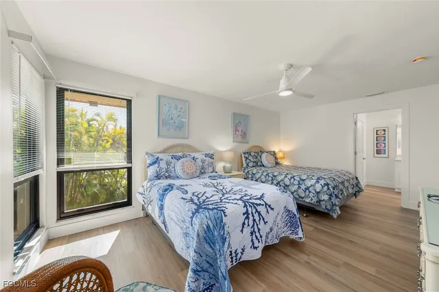 a bedroom with two beds and a window