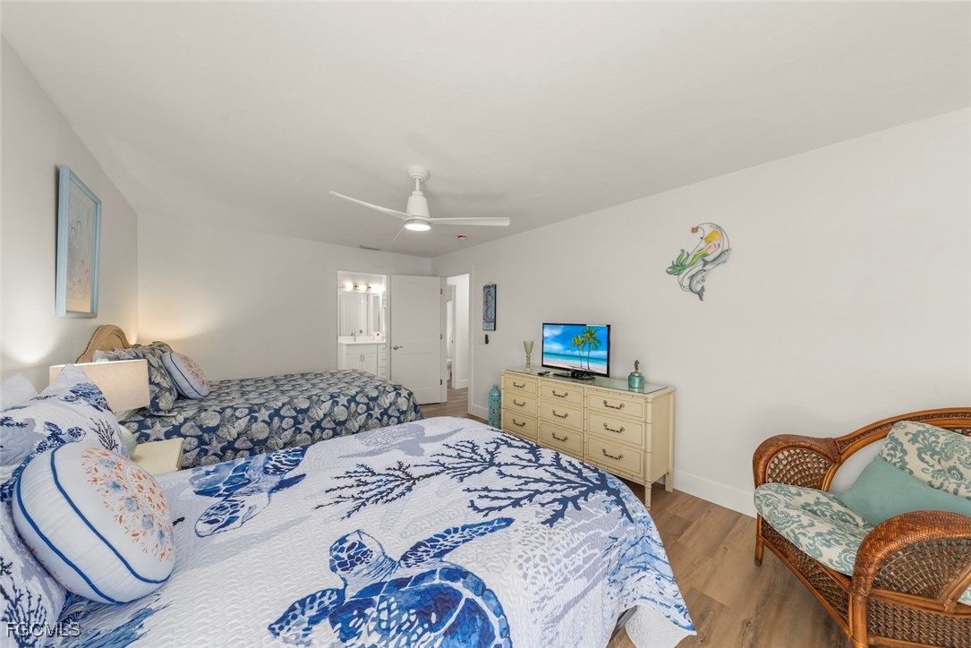 5117 Sea Bell Road, Unit D204 Sanibel, FL 33957 - Photo 41 of 48 a bedroom with a bed and wooden floor