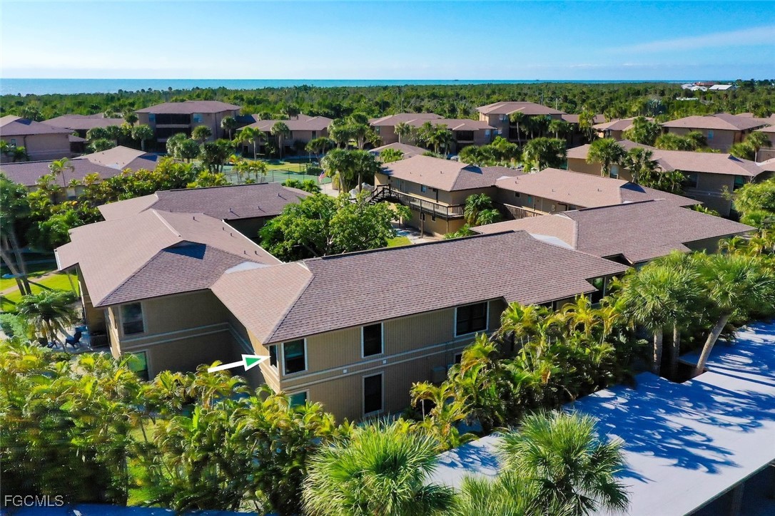 5117 Sea Bell Road, Unit D204 Sanibel, FL 33957 - Photo 43 of 48 an aerial view of multiple houses with yard