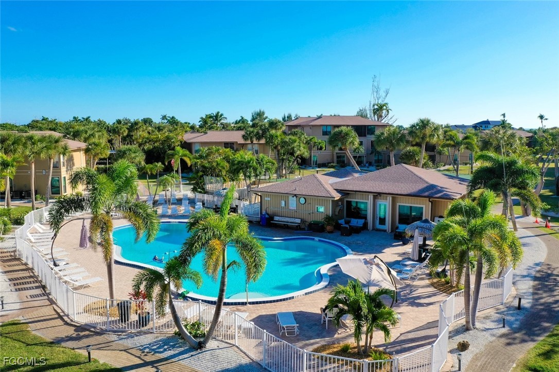5117 Sea Bell Road, Unit D204 Sanibel, FL 33957 - Photo 5 of 48 a view of a patio with furniture and table under an umbrella