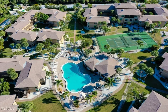 an aerial view of residential houses with outdoor space and parking
