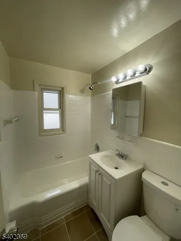 a bathroom with a sink toilet vanity and shower