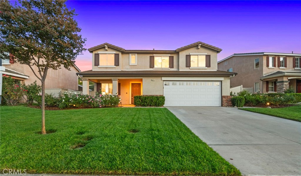 a front view of a house with a yard and garage