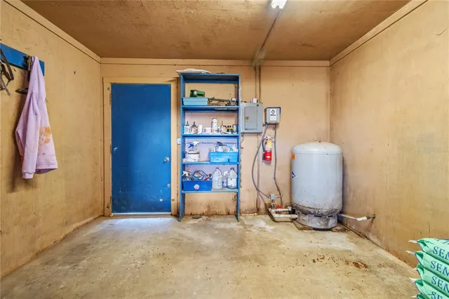 a living room with fireplace furniture and a large window