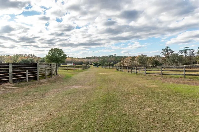 a bathroom with a granite countertop toilet sink and mirror
