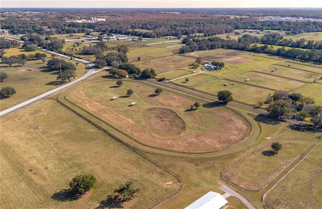 an aerial view of a house with a big yard