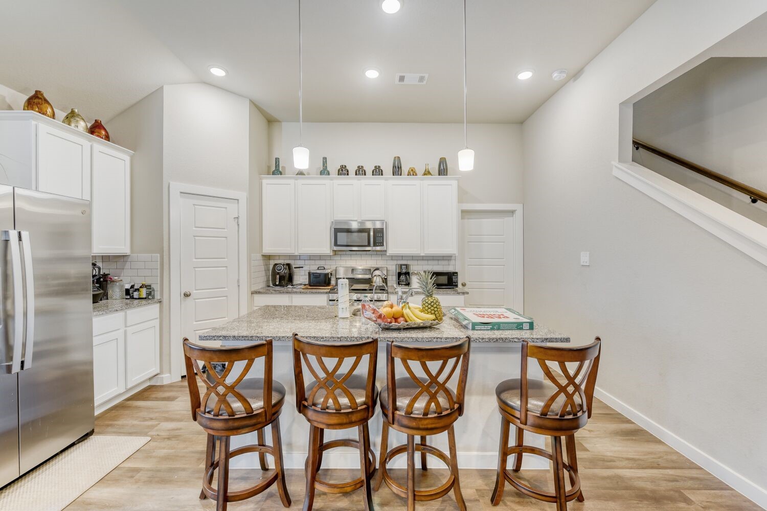 437 Ridge Palm Road Magnolia, TX 77354 - Photo 12 of 31 a kitchen with granite countertop a dining table chairs stainless steel appliances and cabinets