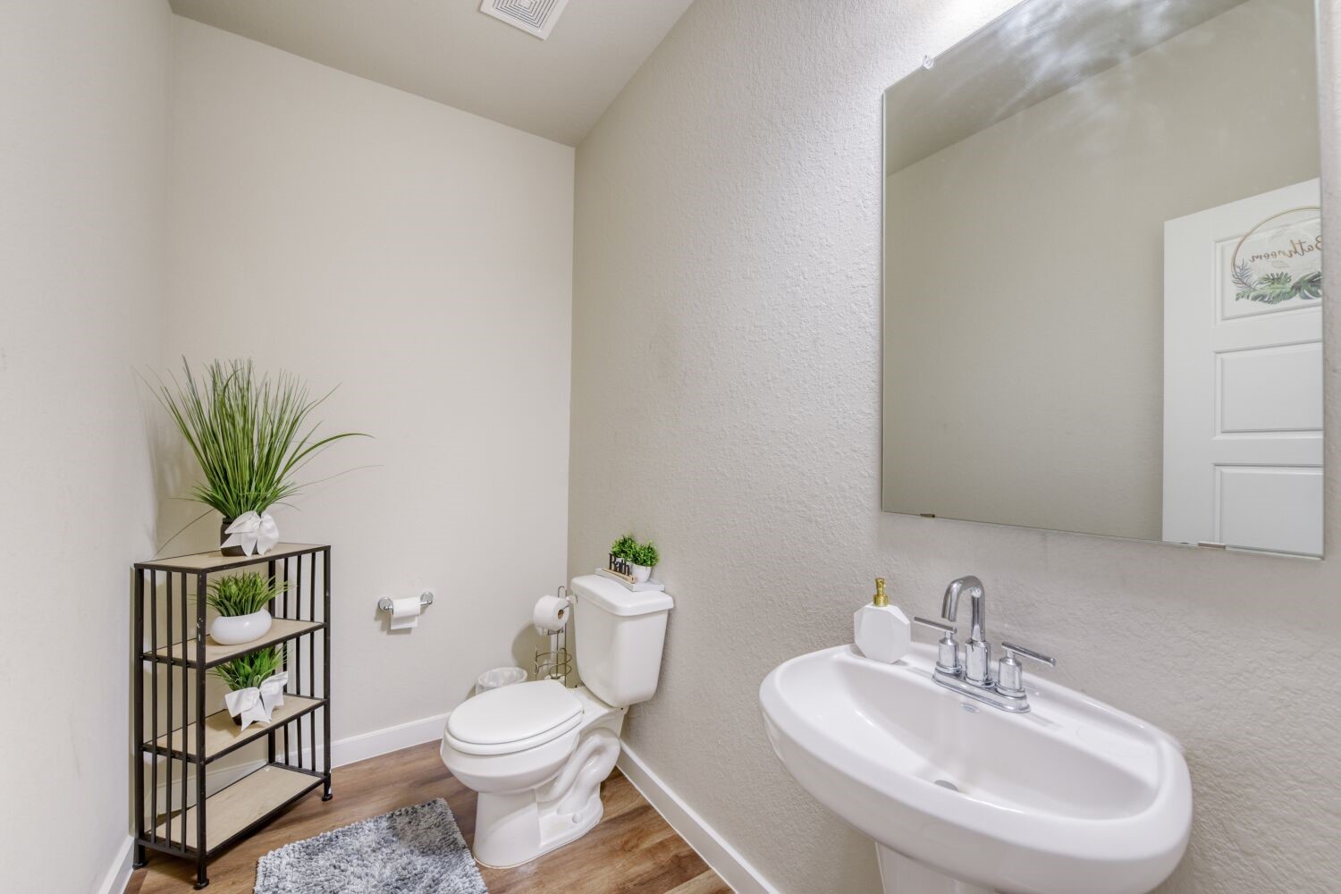 437 Ridge Palm Road Magnolia, TX 77354 - Photo 15 of 31 a white toilet sitting next to a bathroom sink
