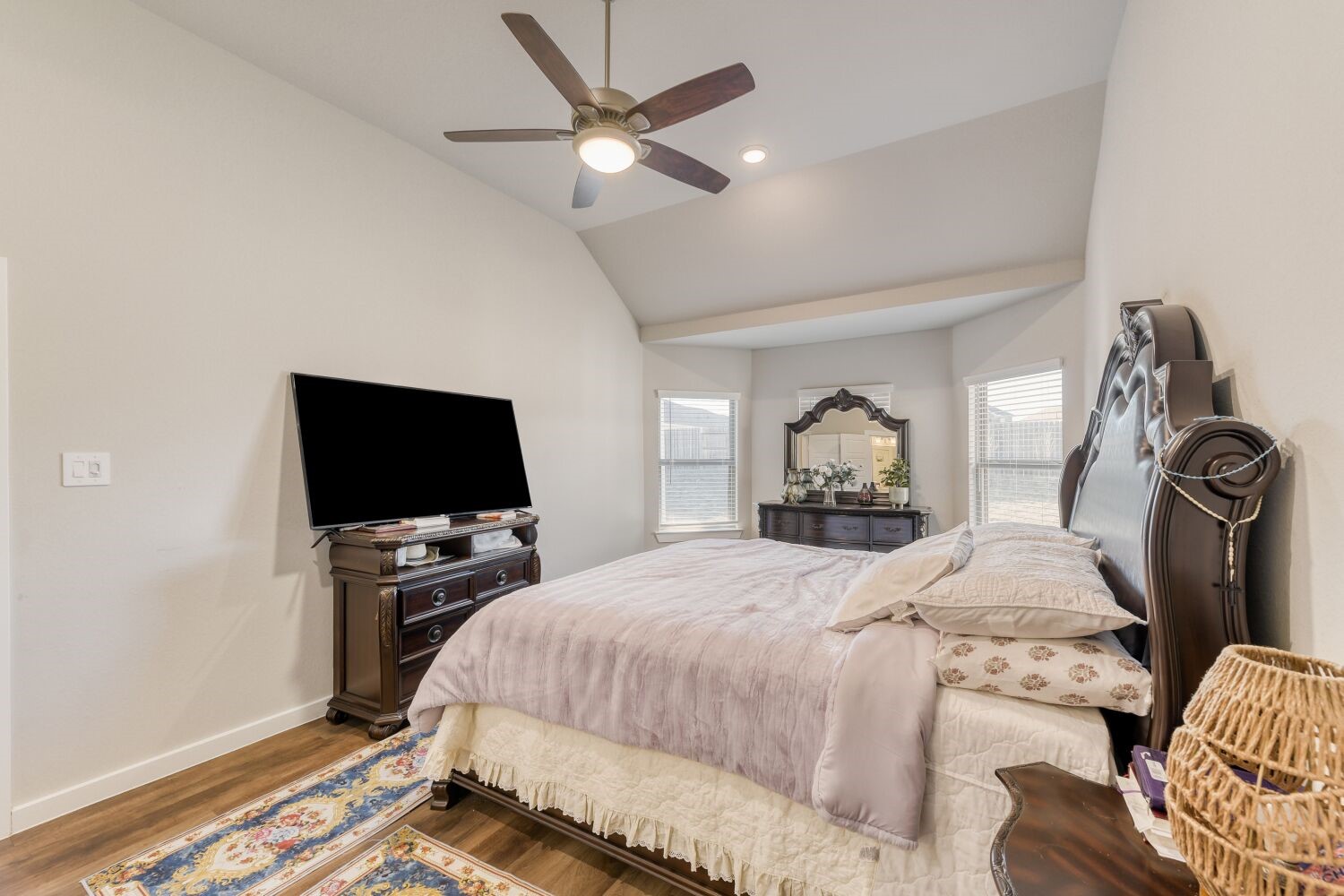 437 Ridge Palm Road Magnolia, TX 77354 - Photo 16 of 31 a bedroom with a bed and a flat tv screen on the dresser