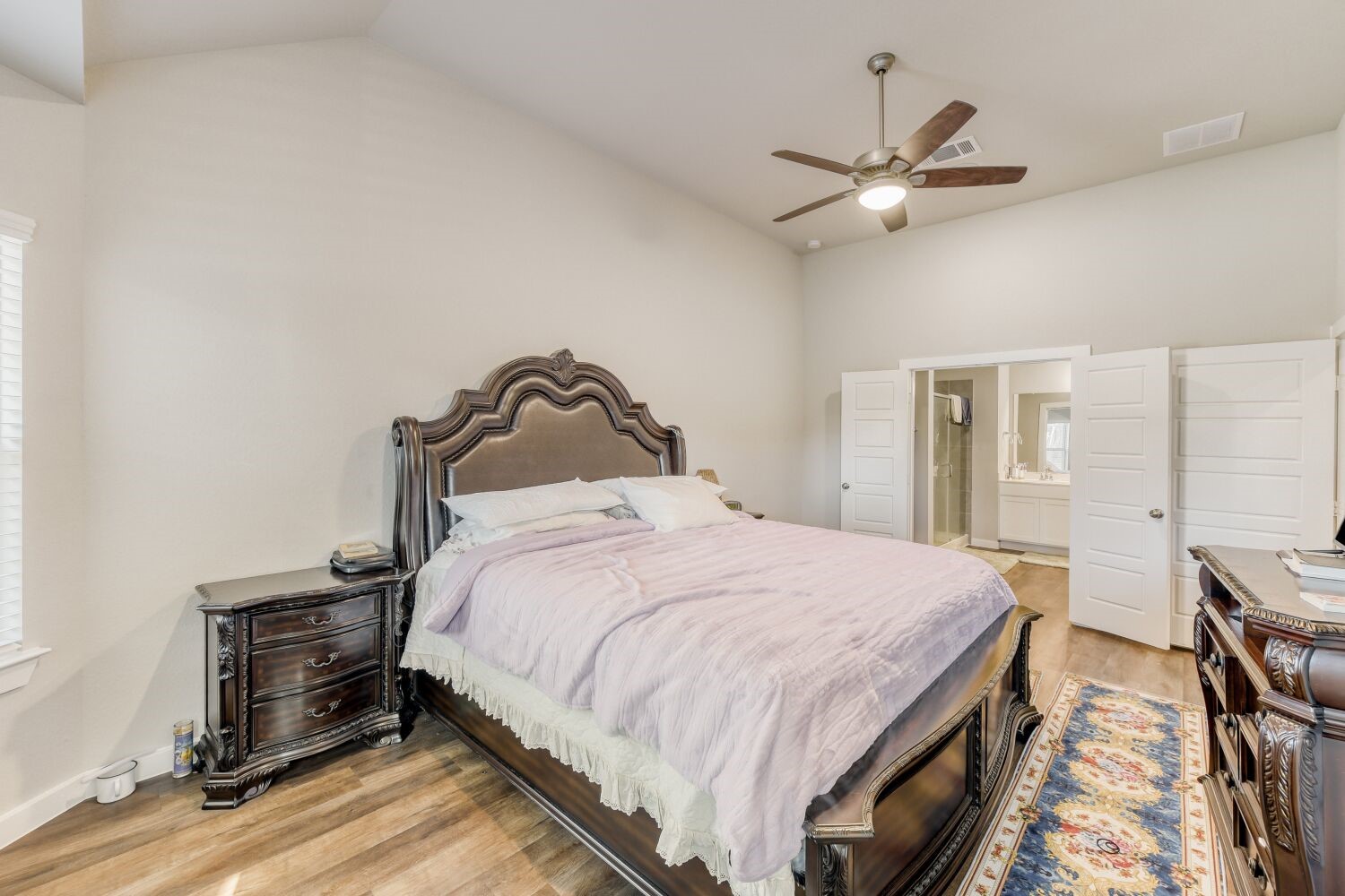 437 Ridge Palm Road Magnolia, TX 77354 - Photo 17 of 31 a bedroom with a bed and a chandelier
