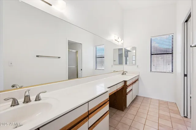 a spacious bathroom with a granite countertop sink and a mirror