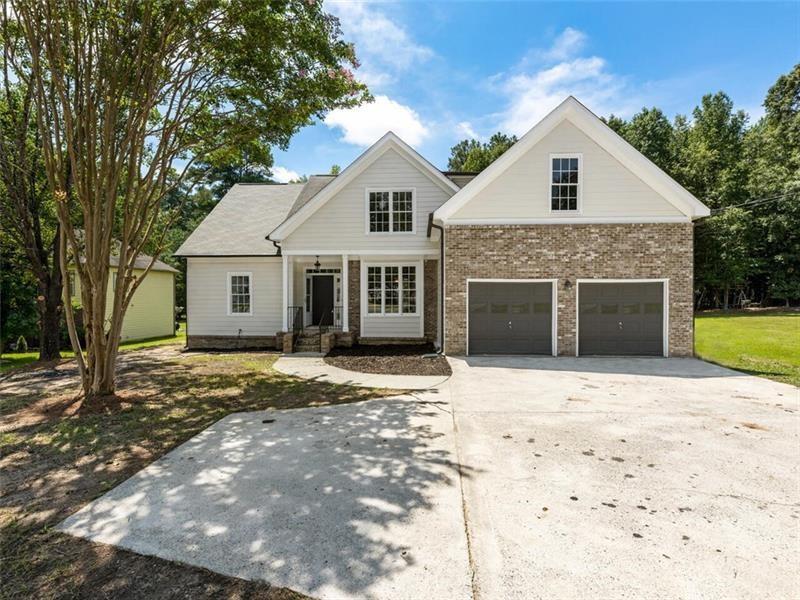 1229 South Gordon Road Southwest Austell, GA 30168 - Photo 1 of 1 a front view of a house with a yard and garage