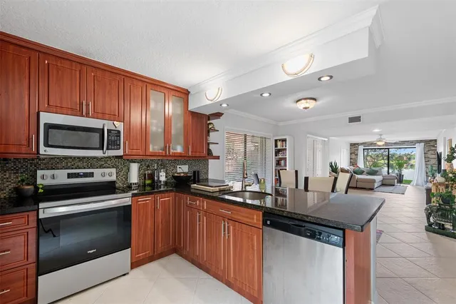 a bathroom with a granite countertop toilet a sink and a mirror