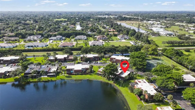 an aerial view of a houses with a lake view