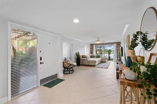 a living room with furniture and a potted plant