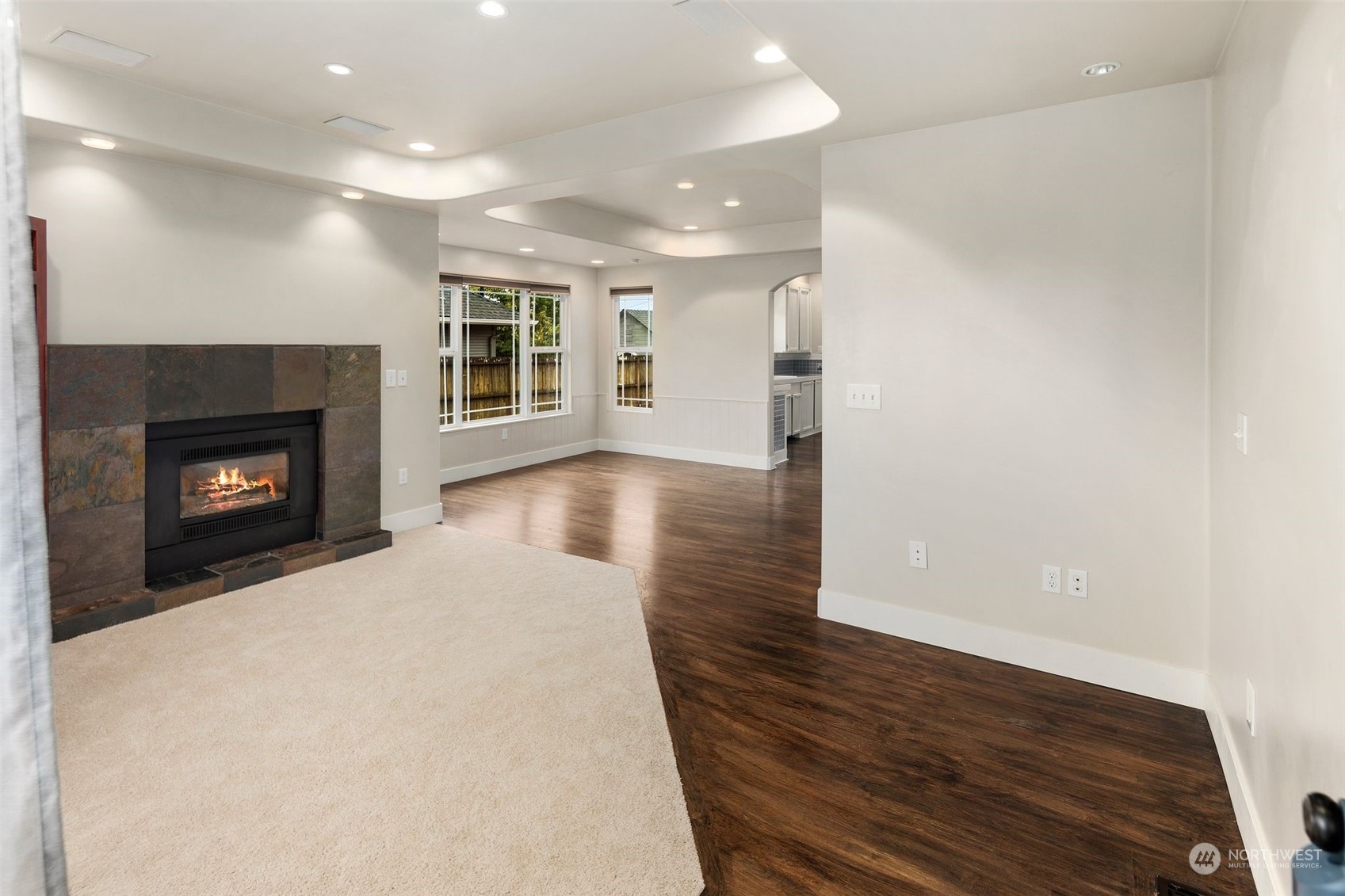 1524 Rockefeller Avenue Everett, WA 98201 - Photo 9 of 37 an empty room with wooden floor fireplace and windows